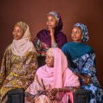 Captivating group portrait of women wearing vibrant traditional attire, showcasing cultural richness.